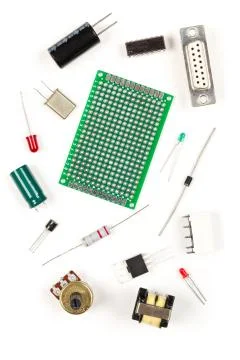 Different electronic parts or components on white with resistors, capacitors, Stock Photos