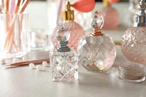 Different elegant perfume bottles on dressing table Stock-Fotos