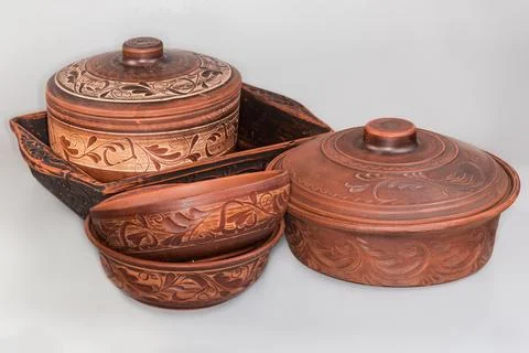Different empty red clay crockery on a gray background Stock Photos