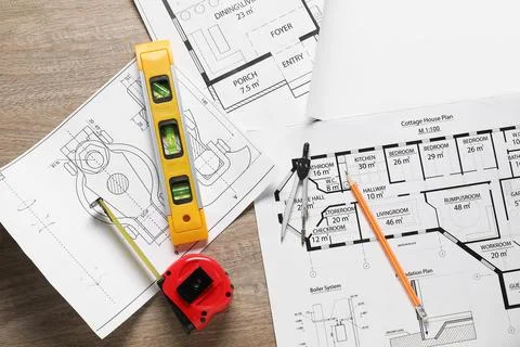 Different engineering drawings, building level, measuring tape, pencil and .. Fotos de archivo