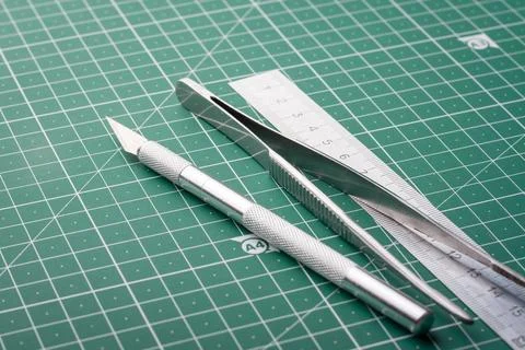 Different equopment forcutting paper on cutting mat Stock Photos