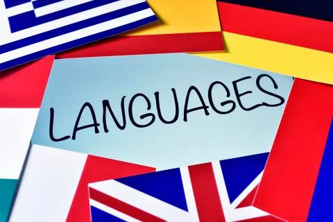 Different flags and the word languages in the screen of a tablet computer Ilustración de archivo