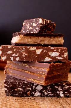 Different flavours of chocolates on a dark background. Stock Photos