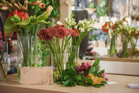 Different flowers on table in shop Stock Photos