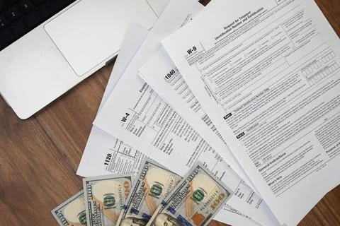 Different forms and dollars on table demonstrate preparation process for Stock Photos
