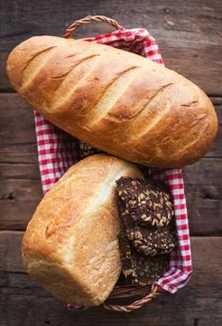 Different fresh bread, on old wooden table. Stock Photos