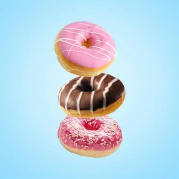 Different fresh donuts on blue background. Minimal food concept. Foto stock