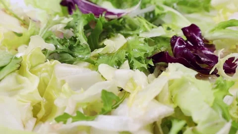 Different fresh green and red lettuce cut salad leaves circle rotation close up Stock Footage 232464991