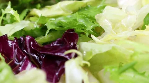 Different fresh green and red lettuce cut salad leaves circle rotation close up Video stock 233998231