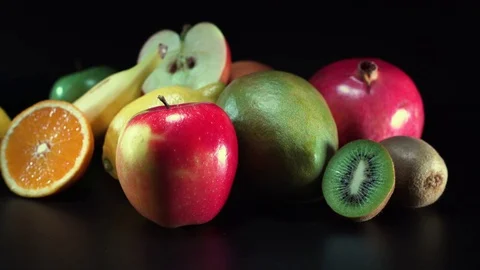 Different fruit on black background, panning Video stock 75824861