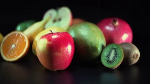 Different fruit on black background, panning, shallow Depth of field Video stock 75826522