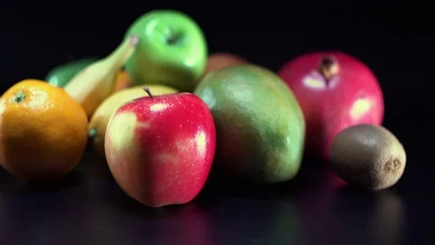 Different fruit on black background, panning, shallow Depth of field Video stock 75832552