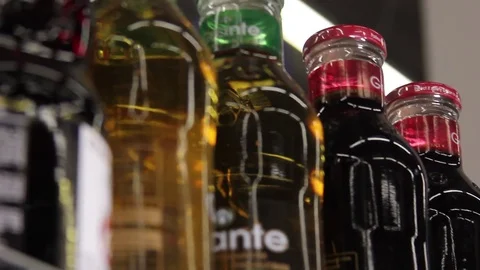 Different fruit juice in glass bottles Stock Footage 75256551