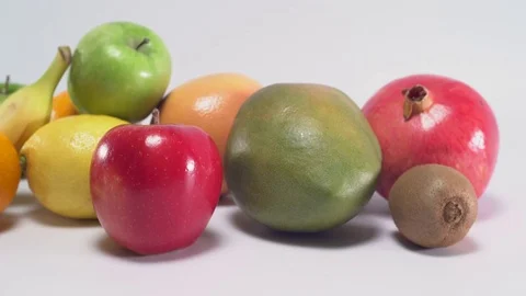 Different fruit on white background, panning movement 스톡 동영상 75816812
