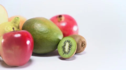 Different fruit on white background, sliding, shallow Depth of field Video stock 75818235
