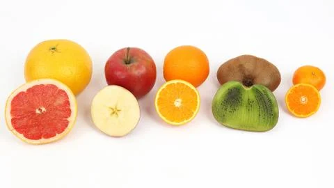 Different fruit whole and sliced on white background Stock Photos