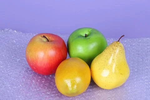 DIfferent fruits on bubble wrap Stock Photos
