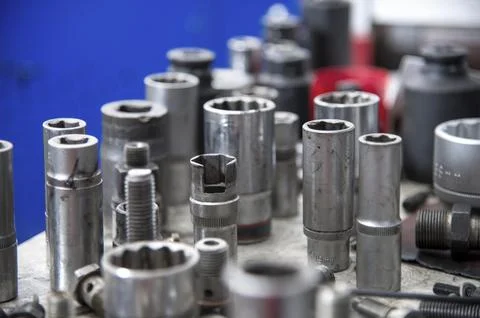 Different fuel bolts and end keys on a workbench in a fuel workshop. Washers and Stock Photos
