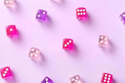 Different game dices on lilac background Stock Photos