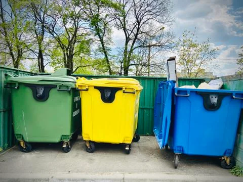 Different garbage containers on the street. Mobile photo. Summer Stock Photos