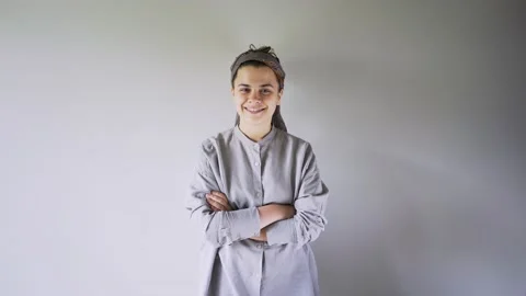 Different garbage falls down onto emotional woman near wall Video stock 135257653