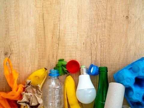 Different garbage on wooden background, top view. Reuse, reduce, recycle concept Stock Photos
