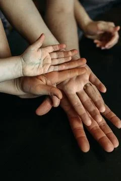 Different generations intertwine their hands, showcasing the beauty of family Stock Photos