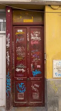 Different graffiti on red door Stock Photos