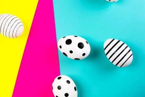 Different graphic hand drawn eggs on bright background in trendy colors. Stock Photos