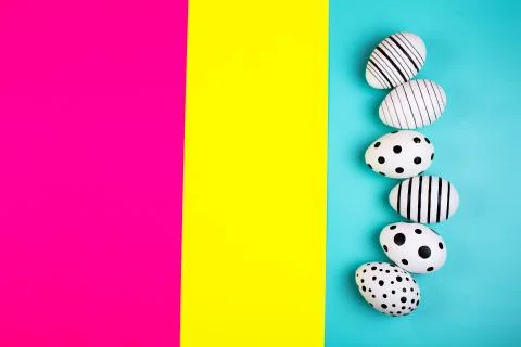 Different graphic hand drawn eggs on bright background in trendy colors. Stock Photos