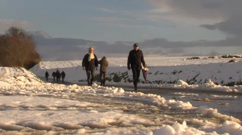 Different groups of people are walking in snowy landscape. Stock Footage 59937788