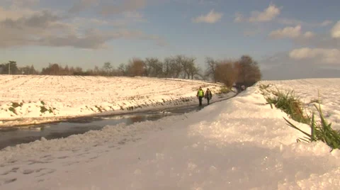 Different groups of people are walking and running in snowy landscape. Stock Footage 59937805