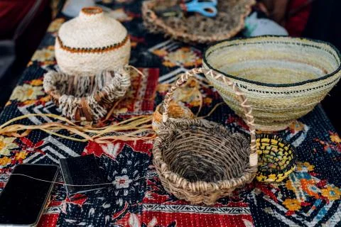 Different hand made weave basckets on table. Craft workshop. Close up shot Stock Photos