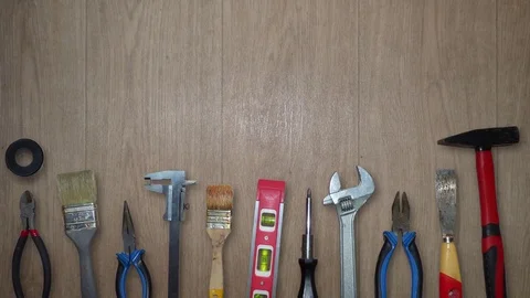 Different hand tools moving on wooden background Stock Footage 76746917