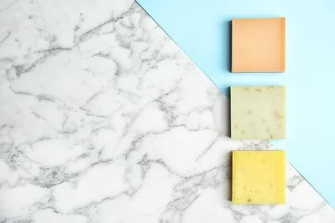 Different handmade soap bars and space for text on marble table, top view 스톡 사진