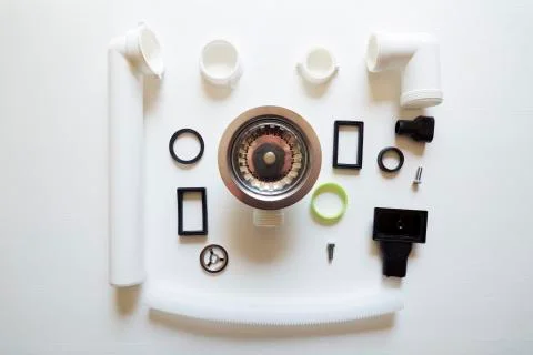 Different hardware elements and tubes for a kitchen sink drain Stock Photos