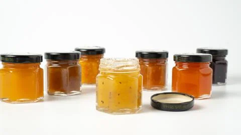 Different jam flavors on white background. Delicious jam in little jars. Set  写真素材