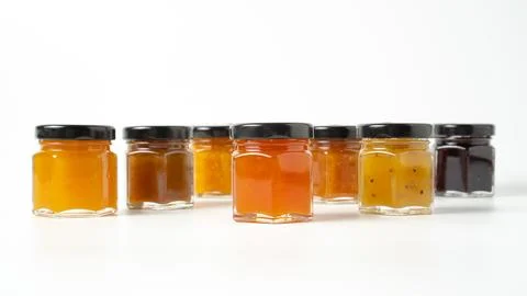 Different jam flavors on white background. Delicious jam in little jars. Set  写真素材