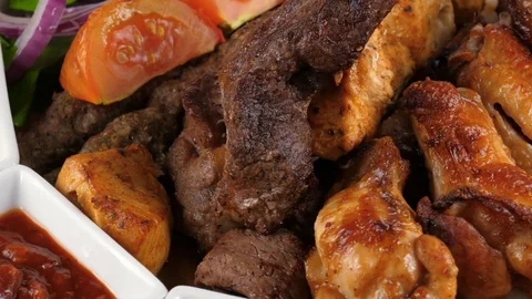 Different kind of barbecued meat with vegetables Stock Footage 78357680