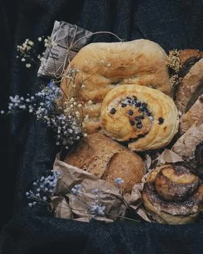 Different kind of bread and bread rolls in a retro style box. Stock Photos