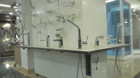 Different kind of faucets on the wall in a store pan display Stock Footage 97509631