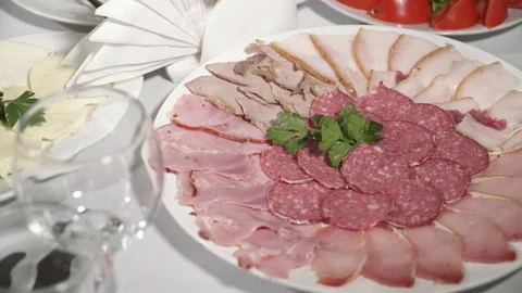 Different kind of meat cuts on the white plate in the cafe Video stock 73516136
