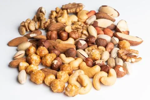 Different kind of nuts on a white surface Stock Photos