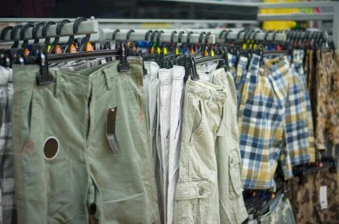 Different kind of shorts with check patterna, stripes and regular in stand in Stock Photos