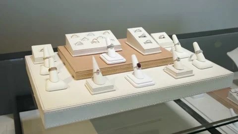 Different kind of silver and gold rings in jewelry shop showcase Stock Footage 132585950