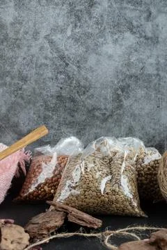 Different kinds of beans packed on a gray background Stock Photos