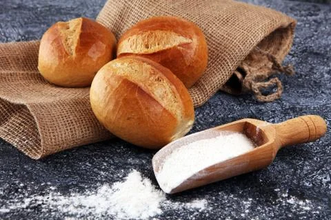Different kinds of bread and bread rolls on board from above. Kitchen or bake Stock Photos