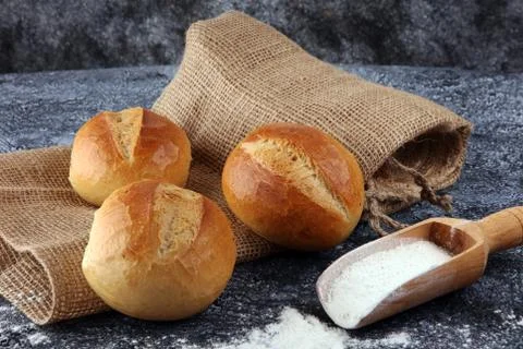 Different kinds of bread and bread rolls on board from above. Kitchen or bake Stock Photos
