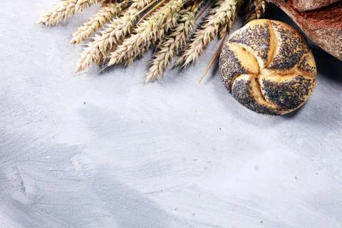 Different kinds of bread and bread rolls on board from above. Kitchen or bake Stock Photos