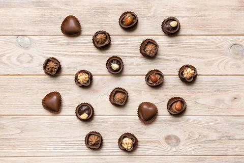 Different kinds of chocolates on colored table close-up. Top View and Flat La Stock Photos